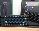 Teclados de efecto Hall Lemokey L1 HE Keychron K4 HE sobre un escritorio frente a una caja y un ordenador portátil