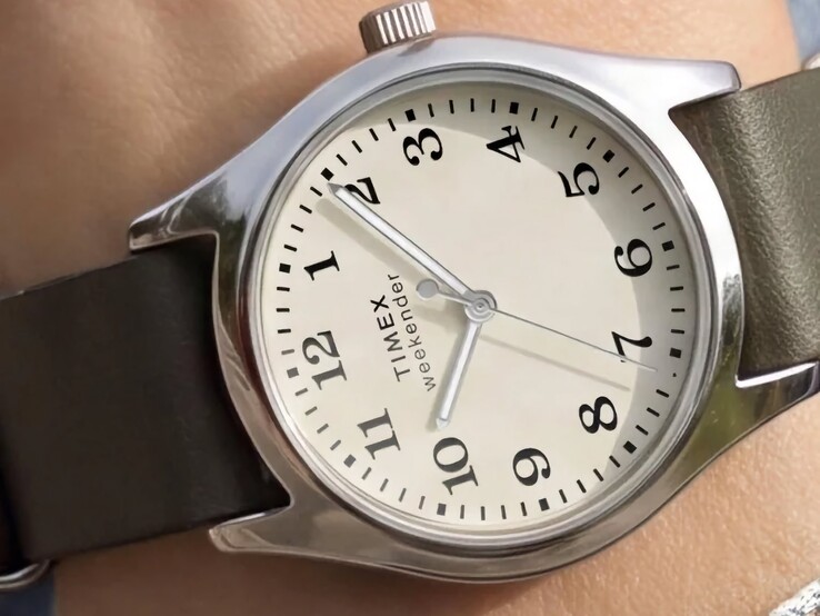 Reloj Timex Weekender New England TW2Y86600, con caja en tono plateado y correa de piel verde oscuro, visto desde un ángulo.