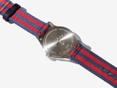 Vista trasera del reloj Noah x Timex MK1 Anchor, en la que se aprecia el fondo de la caja de acero inoxidable grabado y la correa de tela en azul marino y rojo.