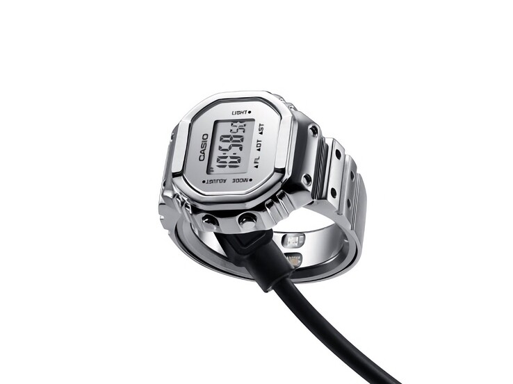 Reloj inteligente Casio CRW-H001M-8 conectado a su cable de carga USB magnético.