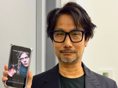 Hideo Kojima mostrando un póster de Physint en su teléfono