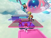 Captura de pantalla de Popucom con personajes sobre plataformas en las nubes resolviendo rompecabezas