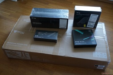 Contenido del paquete: mesa (paquete grande) y accesorios (brazos para monitor, soporte para ordenador portátil, LED RGB, sistema de organización de cables)