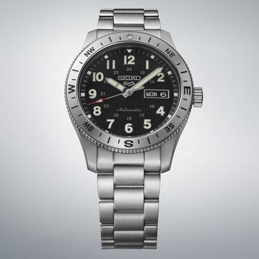 Reloj de campo automático Seiko 5 Sports HDB006 con esfera negra, bisel con brújula y brazalete de acero inoxidable.