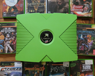 Una Xbox de color verde con 10 títulos retro de Xbox ilustrados