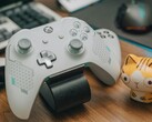 Mando de Xbox blanco descansando sobre un escritorio de madera junto a una pequeña figurita de gato (Fuente de la imagen: FOX ^.ᆽ.^= ∫ via Pexels)